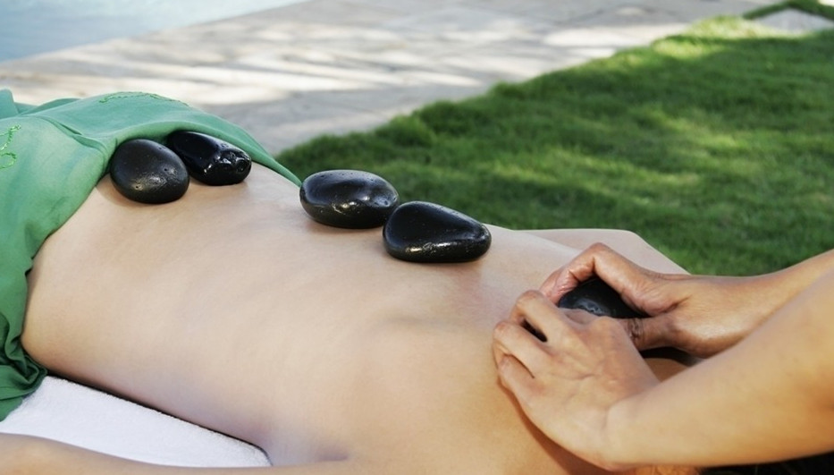 Smooth warm stones used during a back massage