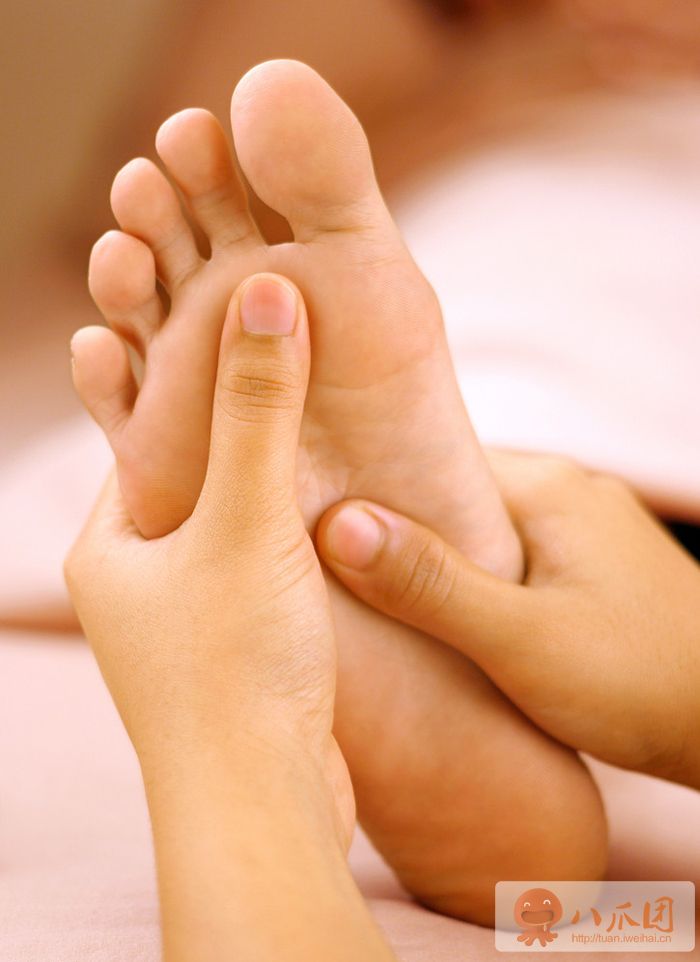 Hands applying pressure to the foot